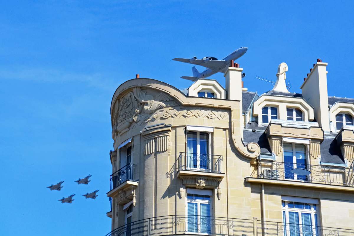 bastille day birds flying over the building during daytime air show